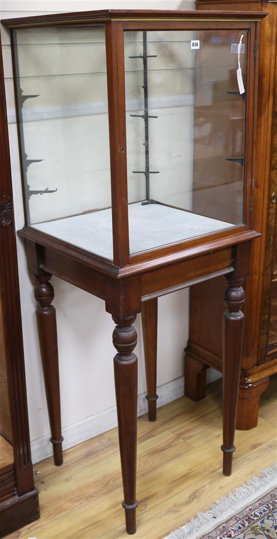 A Victorian mahogany four-glass display cabinet raised on tall, turned, tapered supports, W.57cm